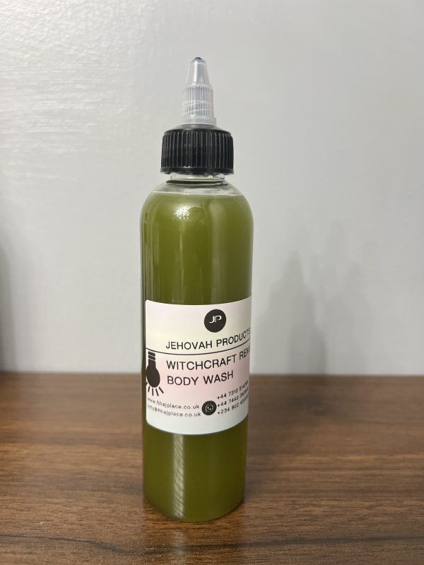 “Bottle of green Jehovah Products Witchcraft Removal Body Wash on a wooden surface.”