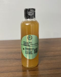  “Bottle of Special Evil Arrows Remover spiritual product with light green label on a wooden surface.”