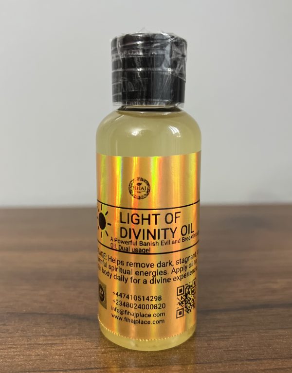 “Small bottle of Light of Divinity Oil with holographic label on a wooden surface, used for spiritual cleansing and energy banishing.”
