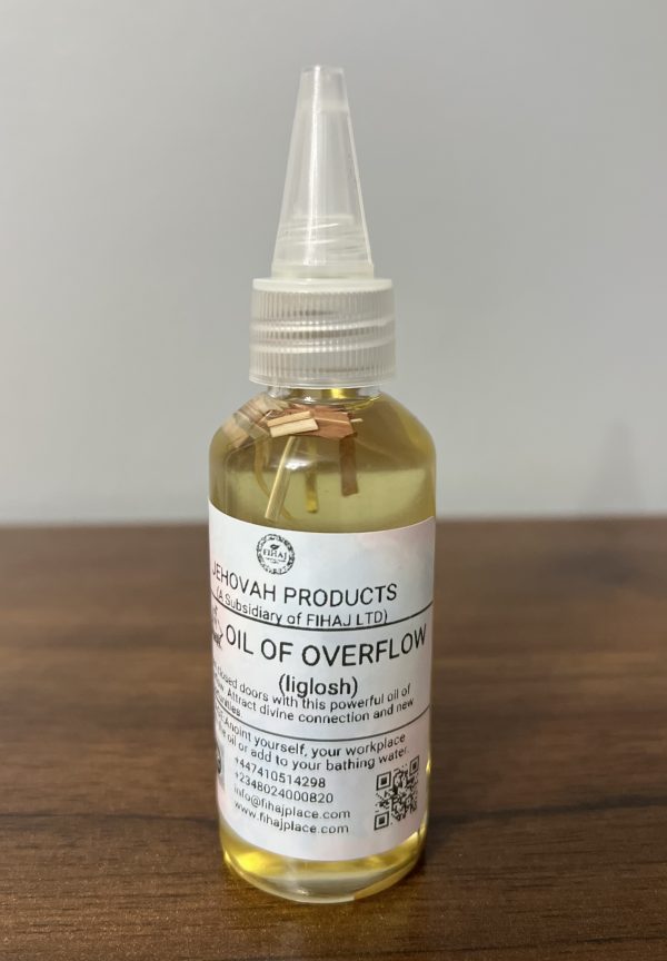 “Bottle of Jehovah Products Oil of Overflow (Iglosh) anointing oil with wooden herbs inside, placed on a wooden surface.”