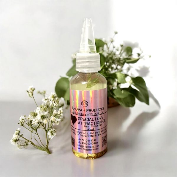 “Bottle of Jehovah Products Special Love Attraction Oil displayed with white flowers and green leaves on a light background.”